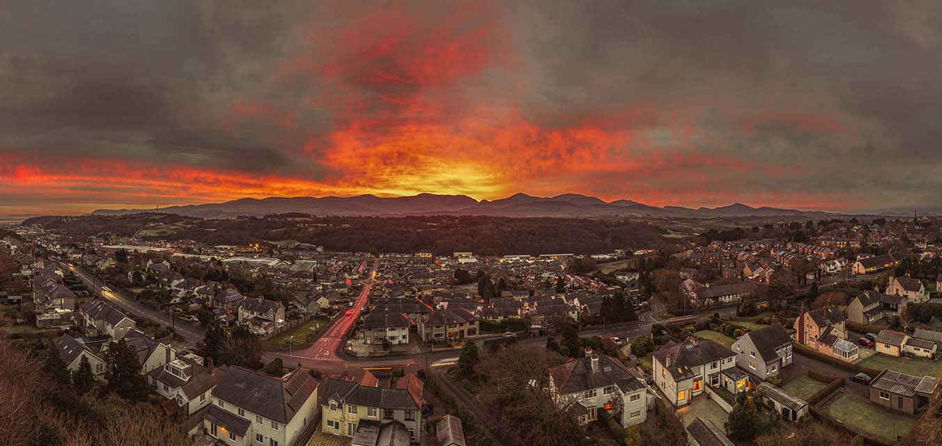 Winter Sunrise over Bangor with the mountains of Snowdonia lit by the flame red sky of the solstice dawn.
