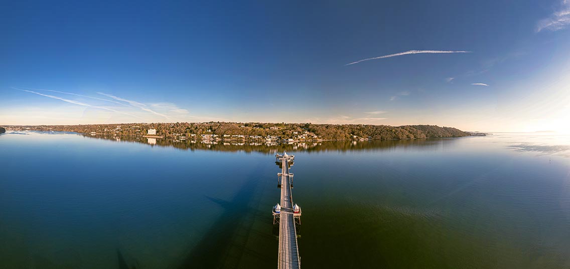 Panoramic view of Bangor Pier - stretching out towards Anglesey on a lovely Spring morning. 2021.